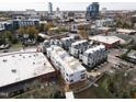 Aerial view of a newly constructed urban townhome community surrounded by a vibrant cityscape at 2002 Moody Ln, Durham, NC 27701