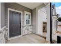 Welcoming front porch with a gray door, stylish stone accents, and covered entryway at 2003 Regal Dr # 90, Durham, NC 27703