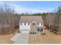 Charming two-story home featuring mixed siding, well-manicured lawn, and attached two-car garage at 2233 Kanata Mills Rd, Wake Forest, NC 27587