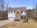 Charming two-story home featuring mixed siding, well-manicured lawn, and attached two-car garage at 2233 Kanata Mills Rd, Wake Forest, NC 27587