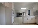 Open-concept kitchen showing cabinetry and seamless flow into living spaces at 2404 Pearces Rd, Zebulon, NC 27597