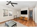 Bright living room with hardwood floors, natural light, and a modern entertainment center at 2409 Keith Dr, Raleigh, NC 27610