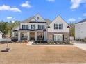 Charming two-story home boasting a well-manicured lawn, stone accents and inviting curb appeal at 2632 Jordan Pointe Blvd, New Hill, NC 27562