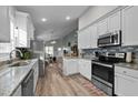 Bright kitchen with granite countertops, modern stainless steel appliances and hardwood flooring at 310 Chub Lake St, Roxboro, NC 27573