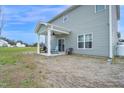 Backyard patio with grill, seating, and ceiling fan at 380 Grameta Ln, Lillington, NC 27546