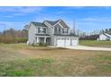 Charming two-story home with three car garage on large lot with mature trees at 380 Grameta Ln, Lillington, NC 27546