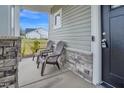 Cozy front porch with two Adirondack chairs and stone accents at 380 Grameta Ln, Lillington, NC 27546