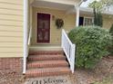 Inviting entryway with a red front door, brick steps, and a charming 'Welcome' mat at 3901 Carson Dr, Sanford, NC 27332
