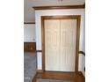 Hallway featuring wood trim and a closet with paneled bi-fold doors at 3901 Carson Dr, Sanford, NC 27332