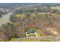 Aerial view of an estate home surrounded by mature trees and serene landscapes at 40 Park Meadow Ln, Youngsville, NC 27596
