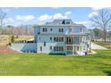 The back of the home features a large screened in porch with access to the backyard and patio at 40 Park Meadow Ln, Youngsville, NC 27596