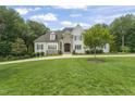 Beautiful two-story home with stone accents, dormer windows, lush lawn, and an inviting entrance at 40 Park Meadow Ln, Youngsville, NC 27596
