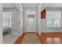Bright foyer featuring hardwood floors, white trim, and a classic front door with sidelights at 400 Oxford Park Blvd, Oxford, NC 27565