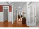 Inviting hallway with gleaming hardwood floors and decorative trim, leading to the living area at 400 Oxford Park Blvd, Oxford, NC 27565