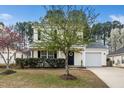 Two story home with white siding, a garage and blossoming trees at 406 Homestead Park Dr. Dr, Apex, NC 27502