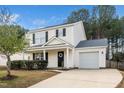 Inviting two-story home with a well-maintained lawn, attached garage, and covered entryway at 406 Homestead Park Dr. Dr, Apex, NC 27502