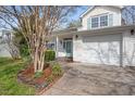 Inviting two-story home with a well-kept lawn, attached garage, and charming front porch at 409 Hanson Rd, Durham, NC 27713