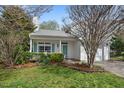 Charming home with a well-manicured lawn, complemented by lush greenery and a welcoming entrance at 409 Hanson Rd, Durham, NC 27713
