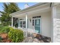 Cozy front porch adorned with tile flooring, showcasing the home's welcoming entrance and charming curb appeal at 409 Hanson Rd, Durham, NC 27713