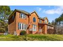 Charming brick home with a manicured lawn and inviting entrance, ideal for Gathering living at 4225 Old Lewis Farm Rd, Raleigh, NC 27604