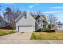 Charming two-story home featuring stone accents, manicured landscaping, and a two-car garage at 4429 Gallatree Ln, Raleigh, NC 27616
