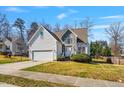 Charming two-story home featuring stone accents, manicured landscaping, and a two-car garage at 4429 Gallatree Ln, Raleigh, NC 27616