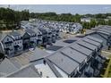 Aerial view of new townhome community showcasing modern design, ample parking, and green spaces at 4810 Gossamer Ln # 105, Raleigh, NC 27616