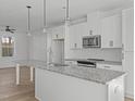 Bright kitchen boasts granite countertops and stainless steel appliances at 4810 Gossamer Ln # 105, Raleigh, NC 27616
