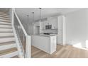 Bright, modern kitchen featuring white cabinetry and a granite island at 4810 Gossamer Ln # 105, Raleigh, NC 27616