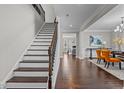 Elegant entryway featuring hardwood floors, staircase, and a glimpse into the formal dining room at 5012 Trembath Ln, Cary, NC 27519