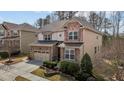 Beautiful two-story home with stone accents, a two-car garage, and lush landscaping at 5012 Trembath Ln, Cary, NC 27519