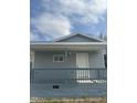 Charming exterior featuring a cozy front porch with white door and gray siding at 513 Woods St, Durham, NC 27703