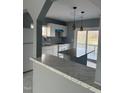 Modern kitchen with granite countertops, white cabinetry, island, and stainless appliances at 513 Woods St, Durham, NC 27703