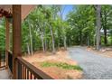 View from the porch of the long driveway lined with trees and gravel at 5507 Eagles Nest Trl, Snow Camp, NC 27349