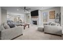 Spacious living room with a brick fireplace, large TV, and ample seating for entertaining guests at 5507 Eagles Nest Trl, Snow Camp, NC 27349