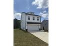 Attractive two-story home featuring white siding, well-kept lawn, and attached two car garage at 553 Winding Creek Dr, Lillington, NC 27546