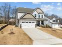 Charming home featuring a two-car garage, a well-manicured lawn, and a welcoming front porch at 63 Capewood Ct, Garner, NC 27529
