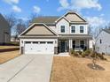 Inviting two-story home with a two-car garage, covered porch, and beautifully landscaped front yard at 63 Capewood Ct, Garner, NC 27529