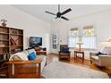 Cozy living room featuring hardwood floors, a ceiling fan, and natural light at 632 E Franklin St, Raleigh, NC 27604