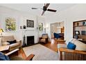 Bright living room with fireplace, hardwood floors, and comfortable seating arrangement at 632 E Franklin St, Raleigh, NC 27604