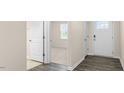 Bright entryway with durable vinyl flooring and a view into the carpeted living area at 71 Hawksmoore Ln, Lillington, NC 27546
