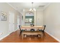 Bright dining room boasts hardwood floors and a stylish table set perfect for gatherings at 7810 Spungold St, Raleigh, NC 27617