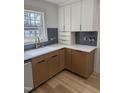 Modern kitchen features shaker cabinets, a white countertop, and stylish backsplash at 82 Cool Creek Dr, Willow Springs, NC 27592