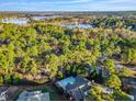 Picturesque aerial view of a community surrounded by lush greenery and a serene lake at 82 Golf Dr, Sanford, NC 27332