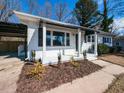 Up-close view of a home's inviting front porch and well-manicured landscaping at 823 Elmira Ave, Durham, NC 27707
