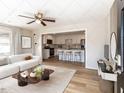 Open-concept living room and kitchen with modern furnishings and lots of natural light at 823 Elmira Ave, Durham, NC 27707