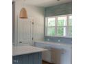 Modern kitchen features stylish lighting, gray backsplash, and white cabinetry at 9231 Bear Run Ln, Middlesex, NC 27557