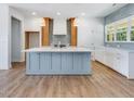Bright kitchen boasts a large island, stainless appliances, and wood floors at 9231 Bear Run Ln, Middlesex, NC 27557