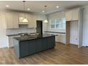 New kitchen features stainless appliances, tile backsplash, granite counters and an eat-in island at 9235 Bear Run Ln, Middlesex, NC 27557
