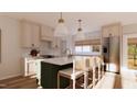 Modern kitchen featuring a marble countertop island with barstool seating, stainless steel appliances, and ample storage at 9235 Bear Run Ln, Middlesex, NC 27557